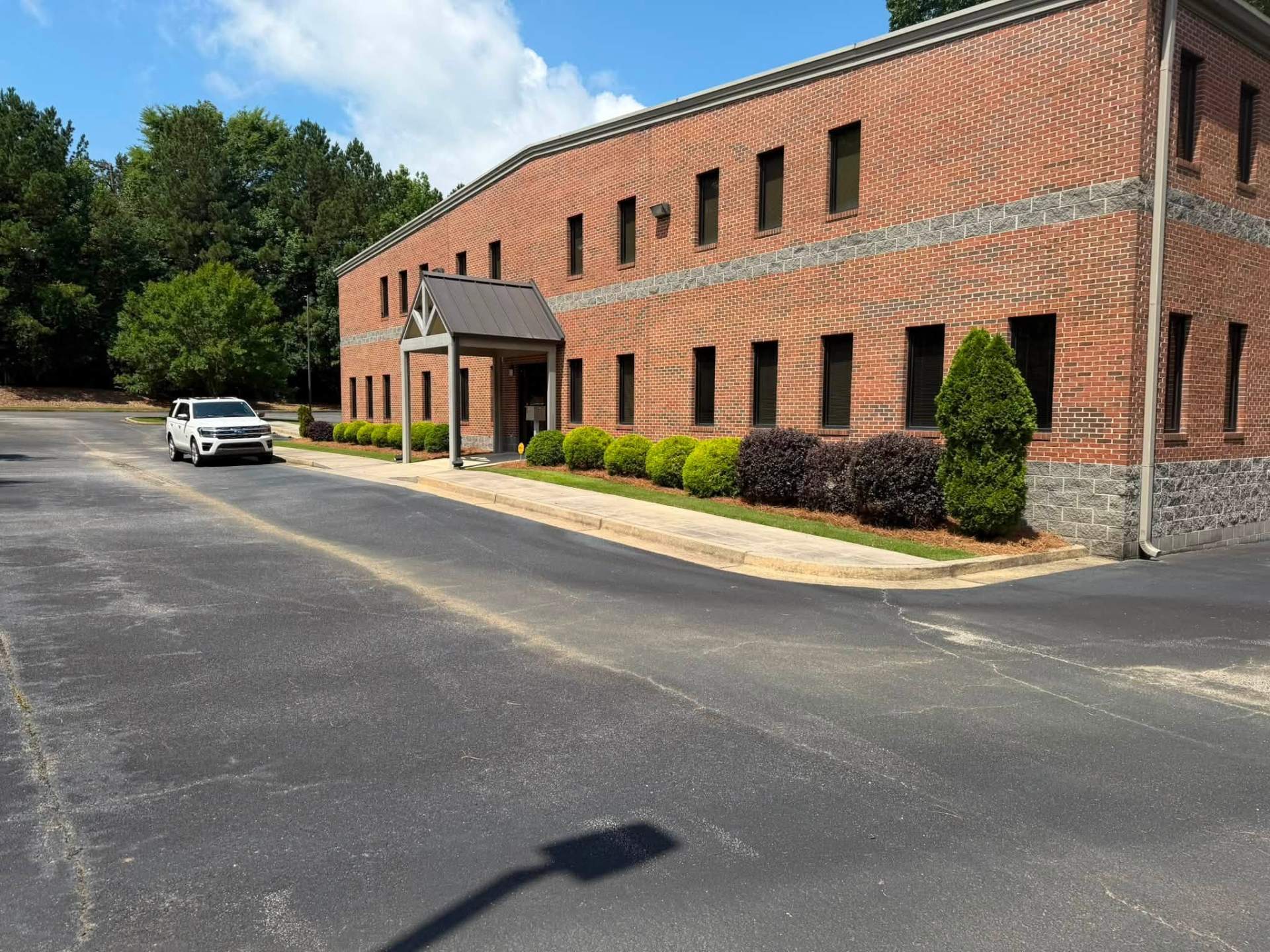 Commercial property landscaping with trimmed shrubs and clean bed lines